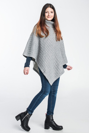 Women's double-sided cape in genuine wool one-colour design different front and back front braided knitted pattern back side